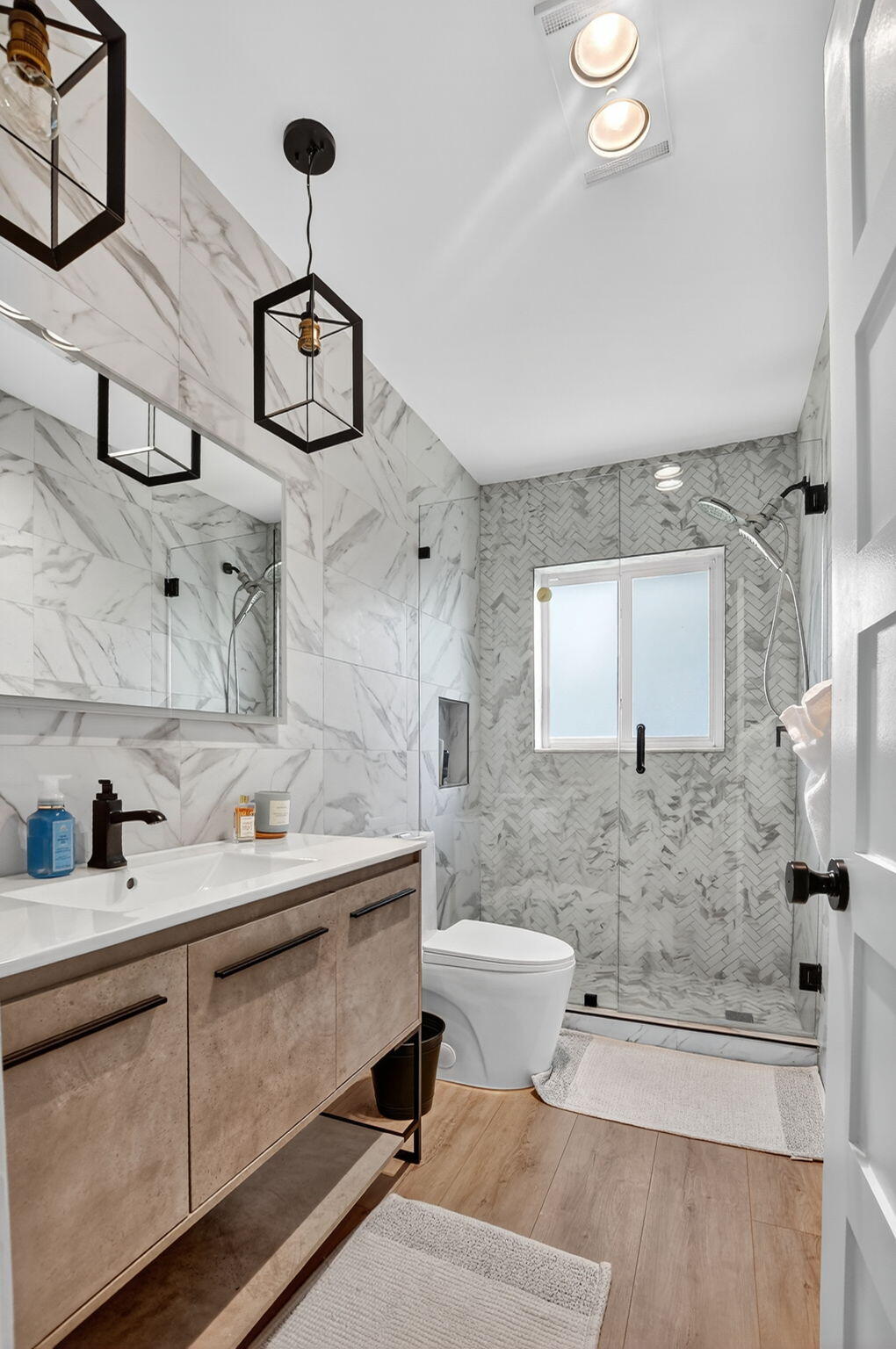 891 Hickory Terrace Boca Raton, FL 33486 - Photo 34 of 56 a bathroom with a toilet sink and mirror