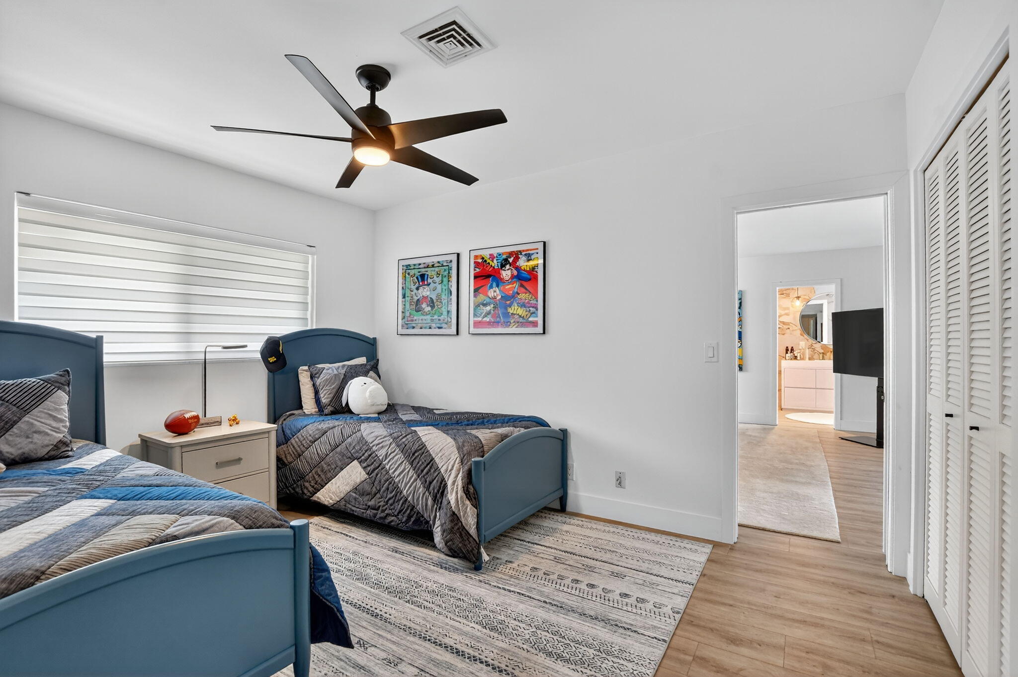 891 Hickory Terrace Boca Raton, FL 33486 - Photo 36 of 56 a bedroom with two beds and a chandelier