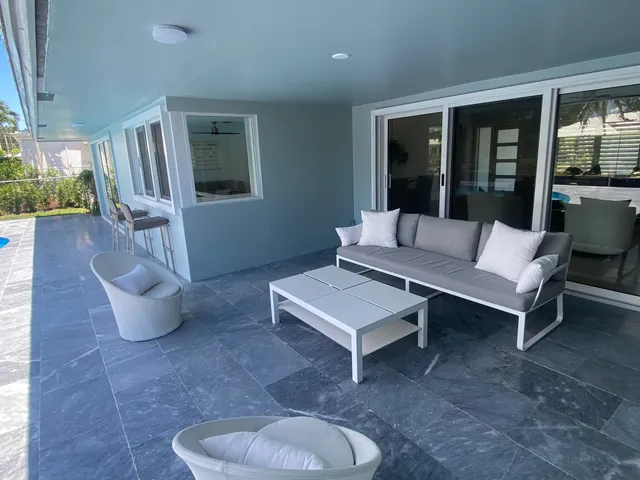 a view of a swimming pool with a lawn chairs and a fire pit