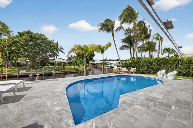 a view of a swimming pool with sitting area
