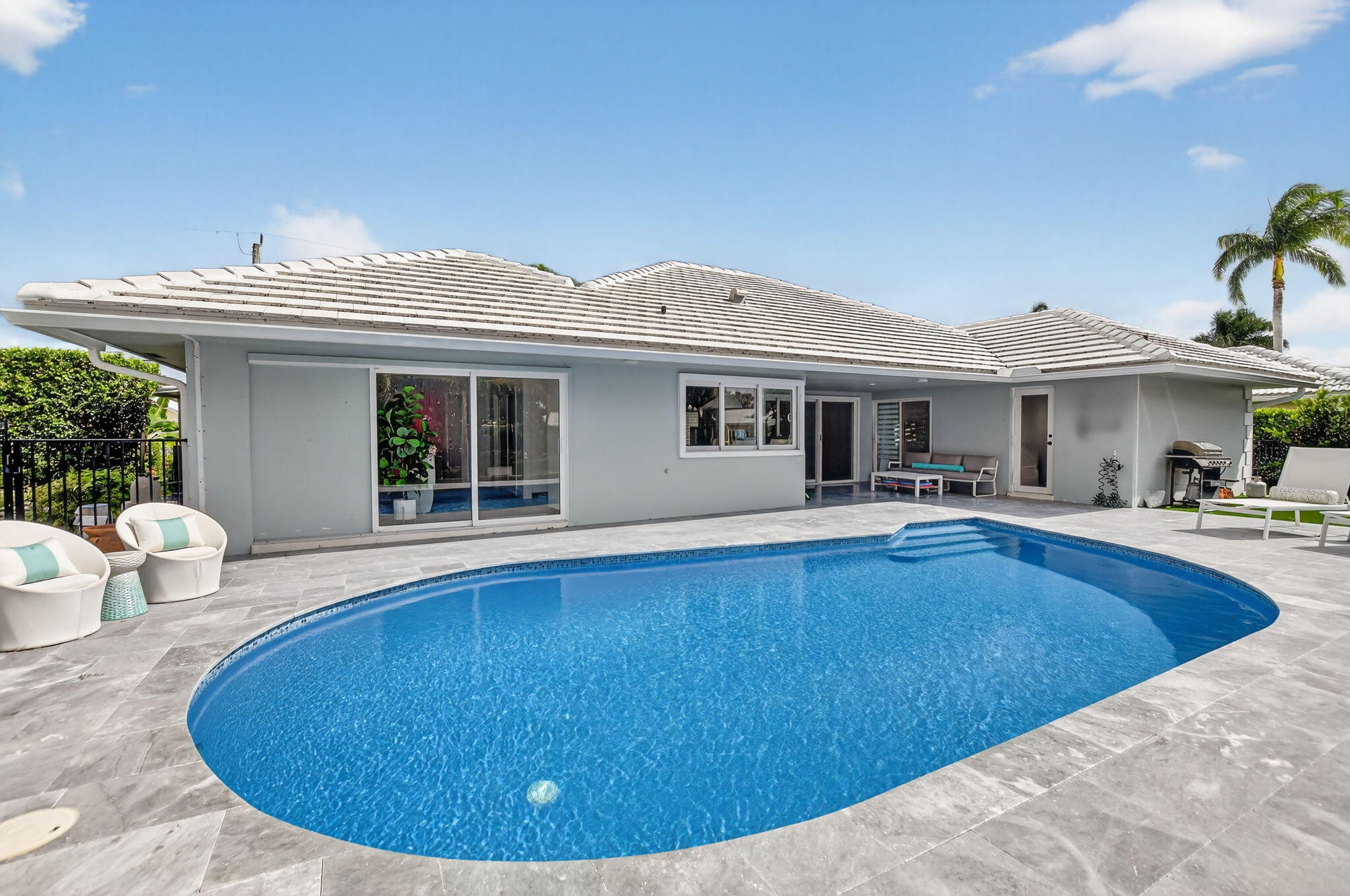 891 Hickory Terrace Boca Raton, FL 33486 - Photo 45 of 56 a view of a house with pool and chairs