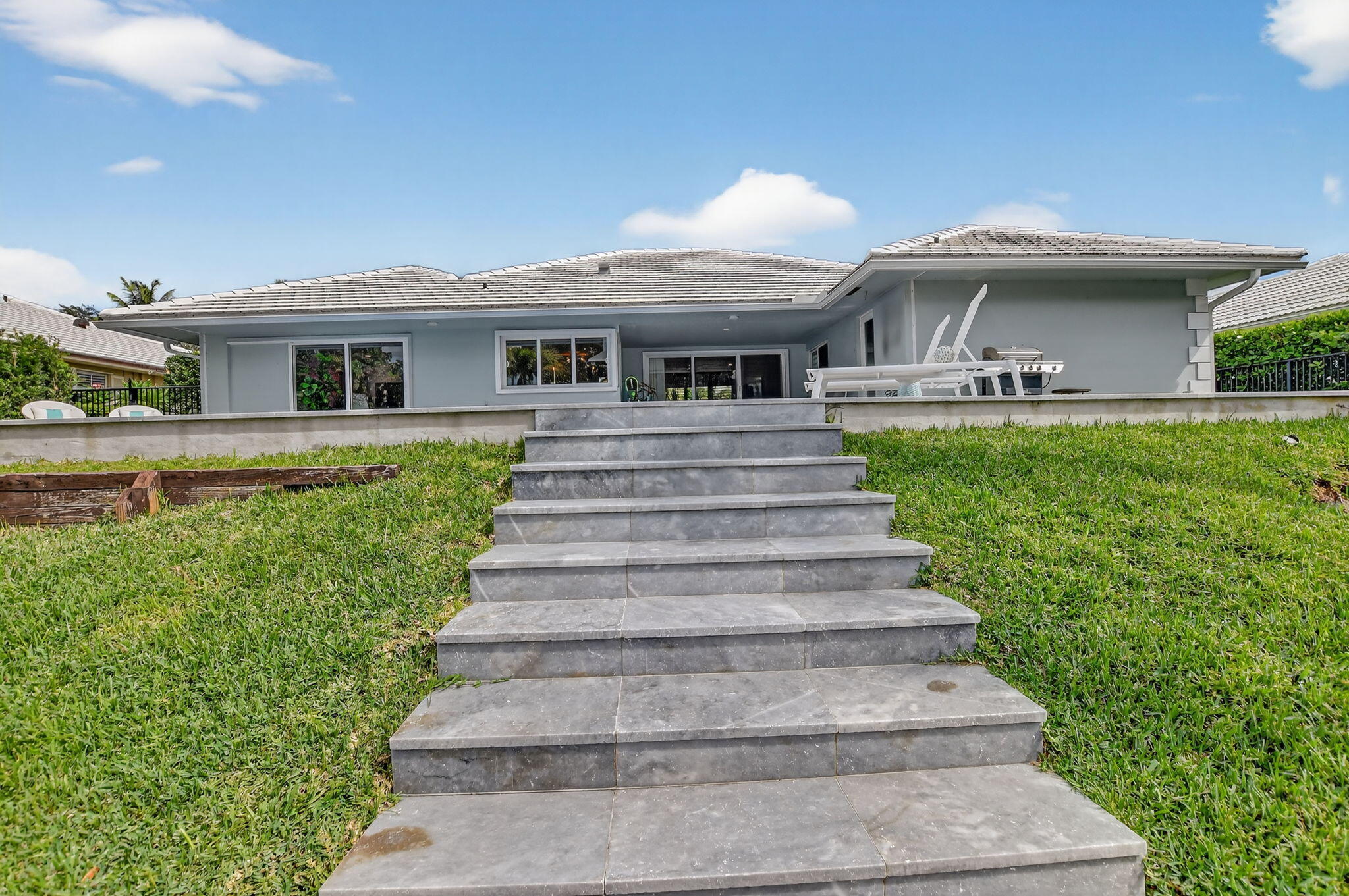 891 Hickory Terrace Boca Raton, FL 33486 - Photo 50 of 56 a front view of a house with a garden
