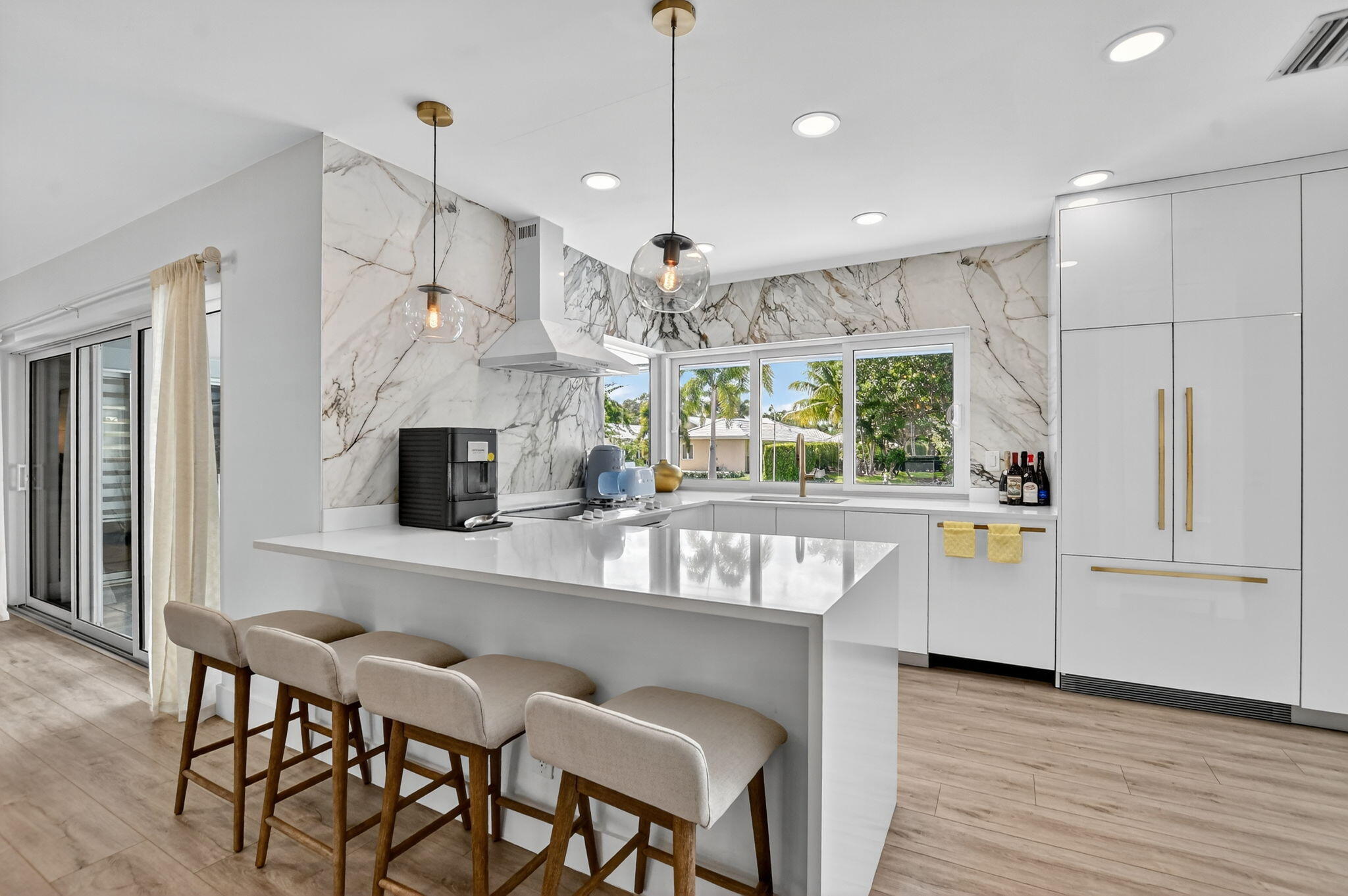 891 Hickory Terrace Boca Raton, FL 33486 - Photo 9 of 56 a kitchen with stainless steel appliances granite countertop a kitchen island hardwood floor and a sink