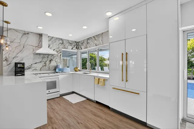 a kitchen with a stove a sink and a microwave