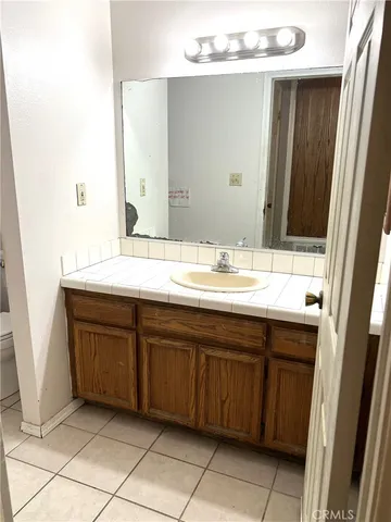 a bathroom with a sink vanity and a mirror