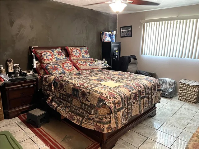 a bed sitting in a bedroom next to a window