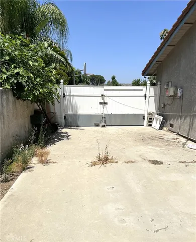 a view of large parking space with a house
