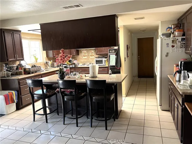 a kitchen with a sink and chairs