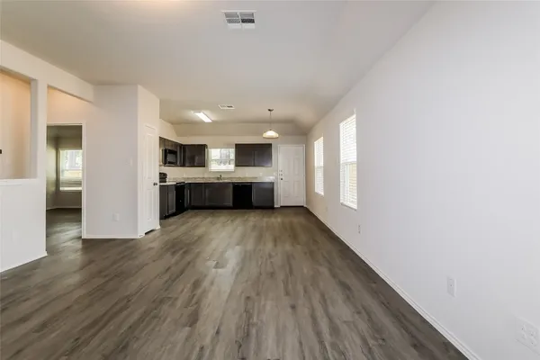 a view of kitchen with cabinets and wooden floor