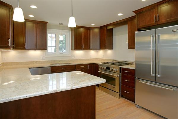 110 Evelyn Road Needham, MA 02494 - Photo 4 of 11 a kitchen with stainless steel appliances a sink and a refrigerator