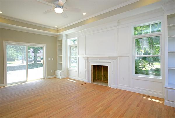 110 Evelyn Road Needham, MA 02494 - Photo 5 of 11 a view of empty room with wooden floor and fireplace