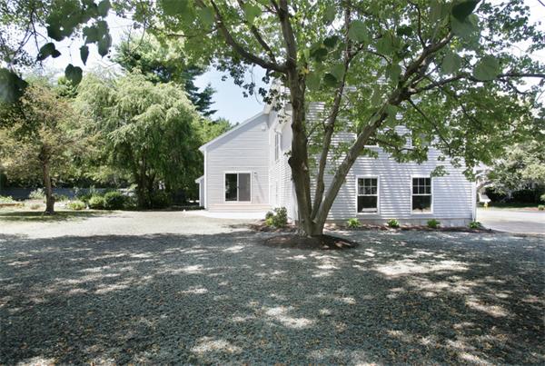 110 Evelyn Road Needham, MA 02494 - Photo 10 of 11 a view of a white house with a yard and large tree