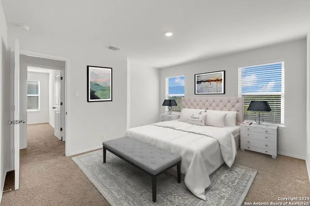 a bedroom with a bed and a couch