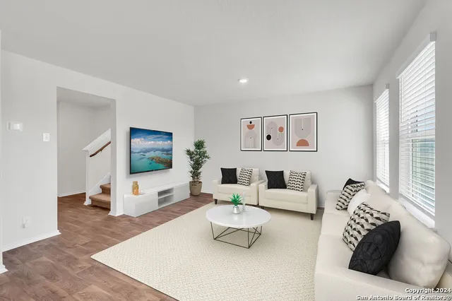 a living room with furniture and a flat screen tv