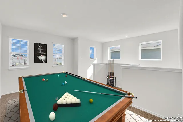 a room with pool table and mirror