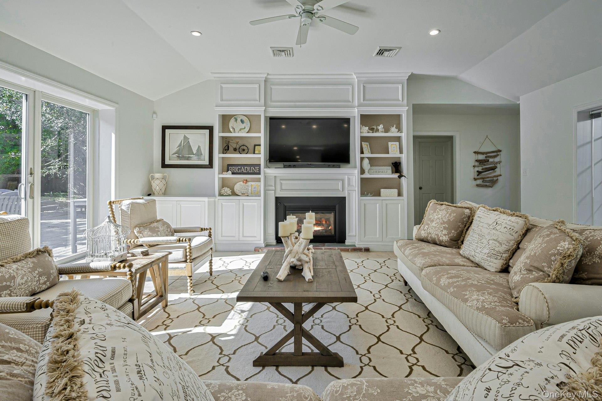 39 Sloop Walk Ocean Beach, NY 11770 - Photo 14 of 46 Living area featuring vaulted ceilings, fireplace, recessed lighting, and a ceiling fan