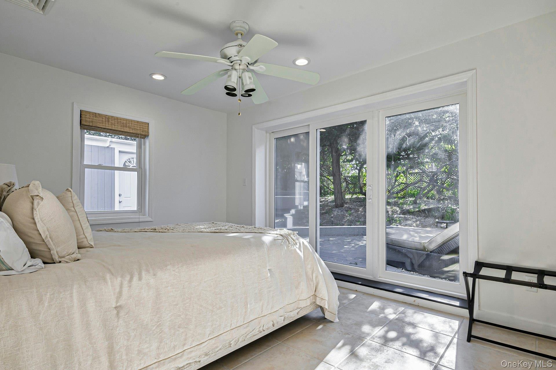 39 Sloop Walk Ocean Beach, NY 11770 - Photo 28 of 46 Room featuring a white ceiling fan with integrated lighting, recessed lighting, and a window with a woven shade