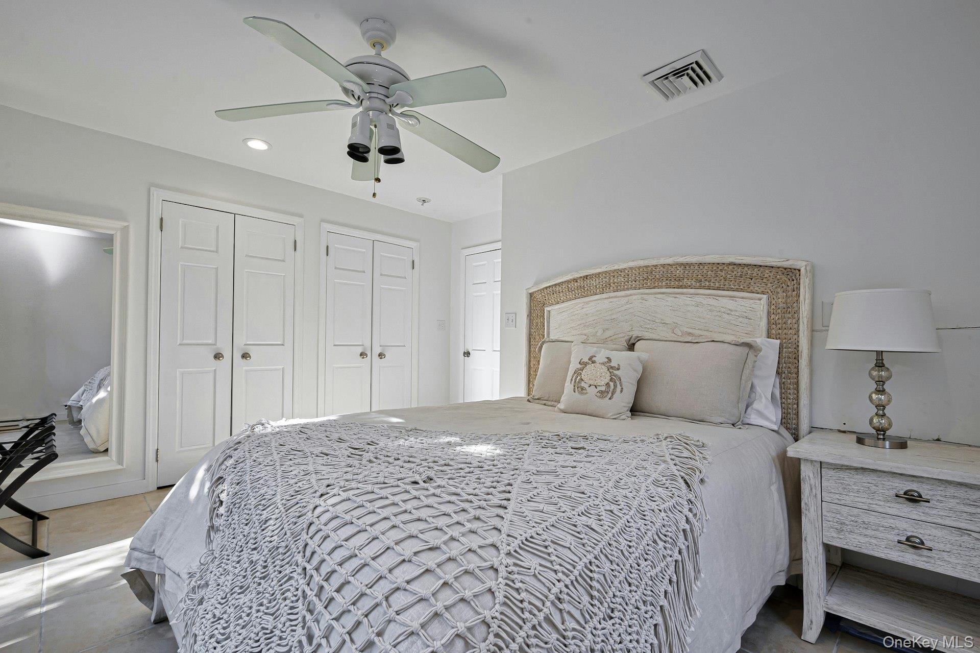 39 Sloop Walk Ocean Beach, NY 11770 - Photo 29 of 46 Bedroom featuring a ceiling fan with integrated lighting, multiple paneled closet doors, and recessed lighting