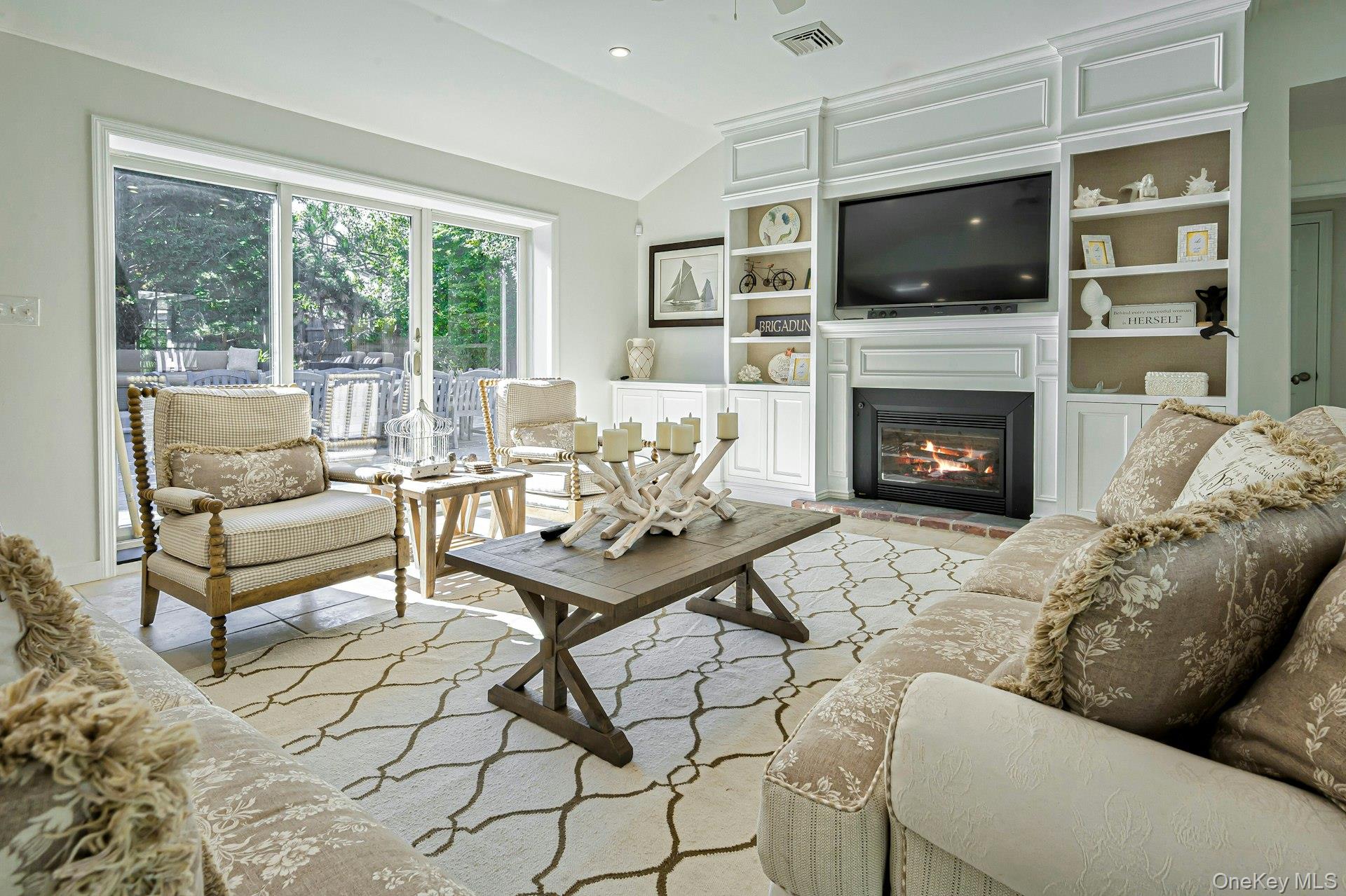 39 Sloop Walk Ocean Beach, NY 11770 - Photo 3 of 46 Living area featuring a vaulted ceiling and sliding glass doors to the exterior