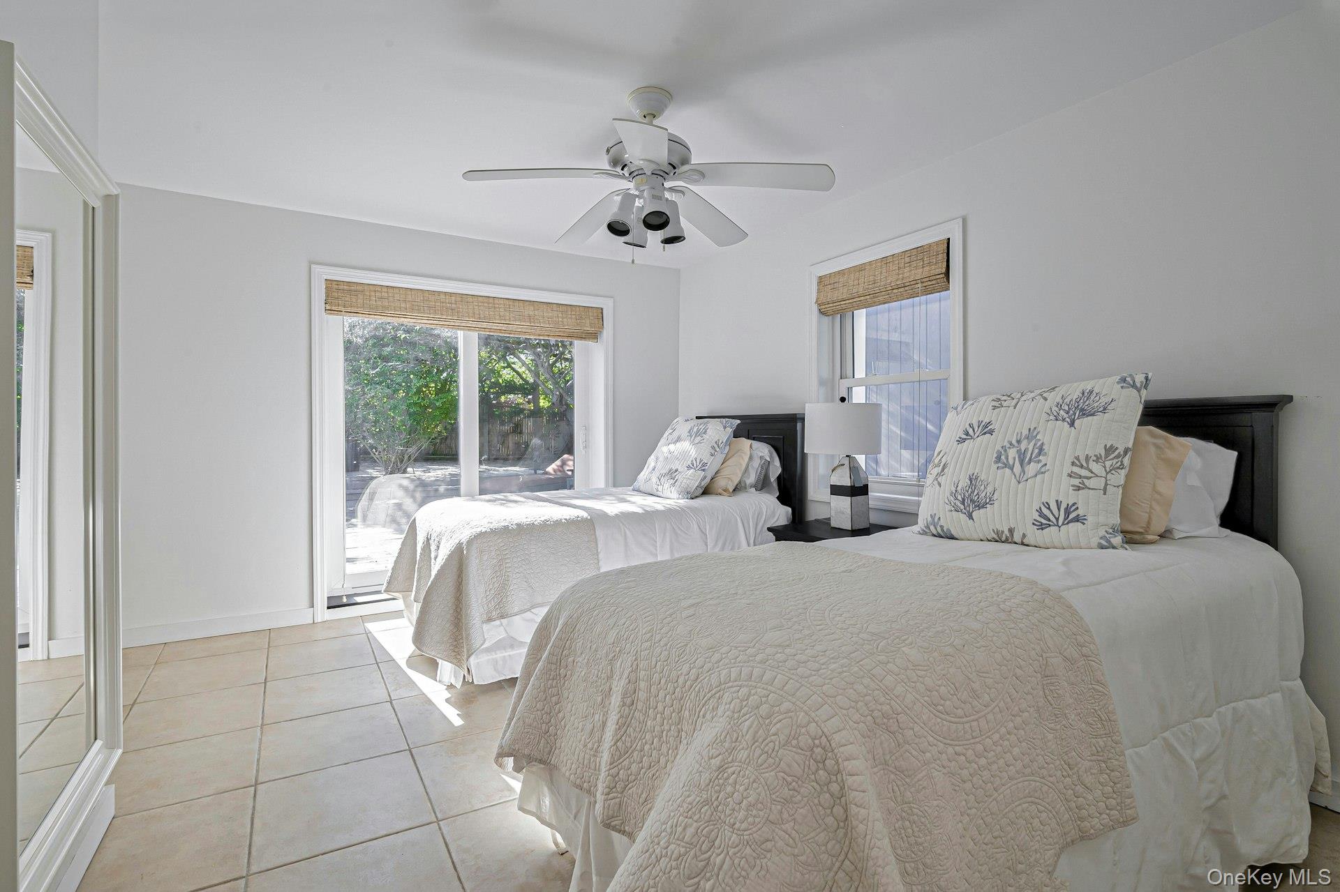 39 Sloop Walk Ocean Beach, NY 11770 - Photo 31 of 46 Bright room featuring neutral-toned tile flooring, a white ceiling fan, and white walls