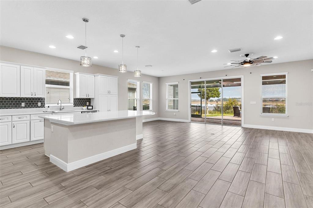 224 Silver Maple Road Groveland, FL 34736 - Photo 11 of 54 a view of kitchen with granite countertop stainless steel appliances refrigerator oven stove microwave and cabinets
