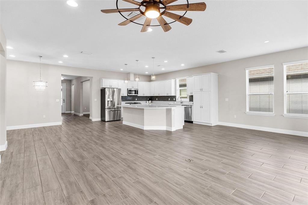 224 Silver Maple Road Groveland, FL 34736 - Photo 12 of 54 a view of a kitchen with a stove cabinets and wooden floor
