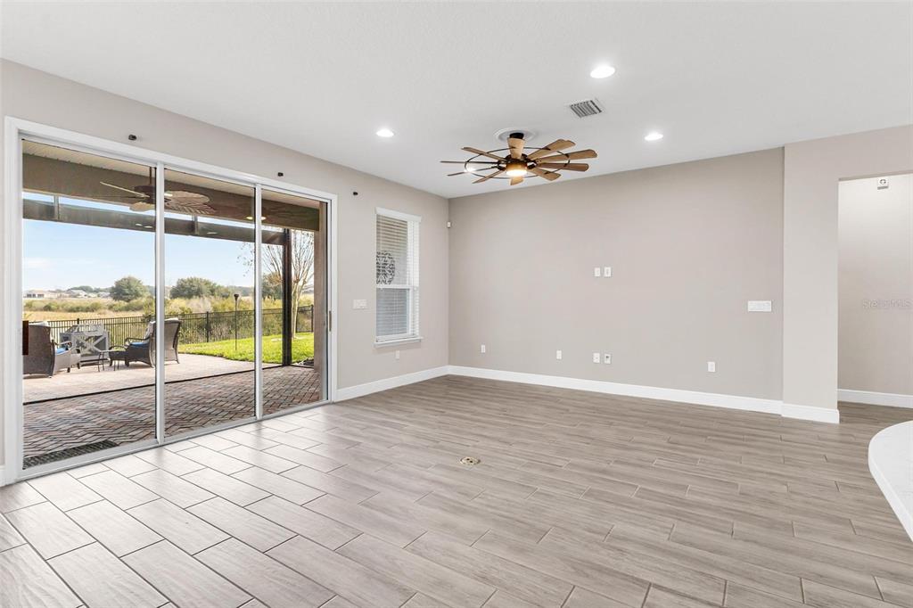 224 Silver Maple Road Groveland, FL 34736 - Photo 14 of 54 a view of an empty room with glass door