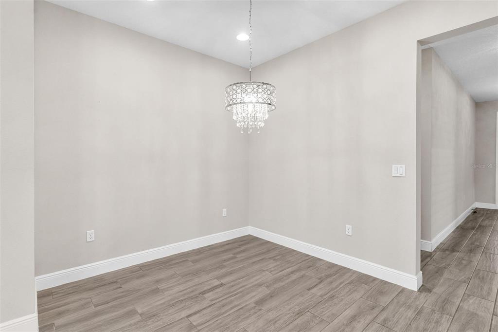 224 Silver Maple Road Groveland, FL 34736 - Photo 15 of 54 a room with wooden floor and windows