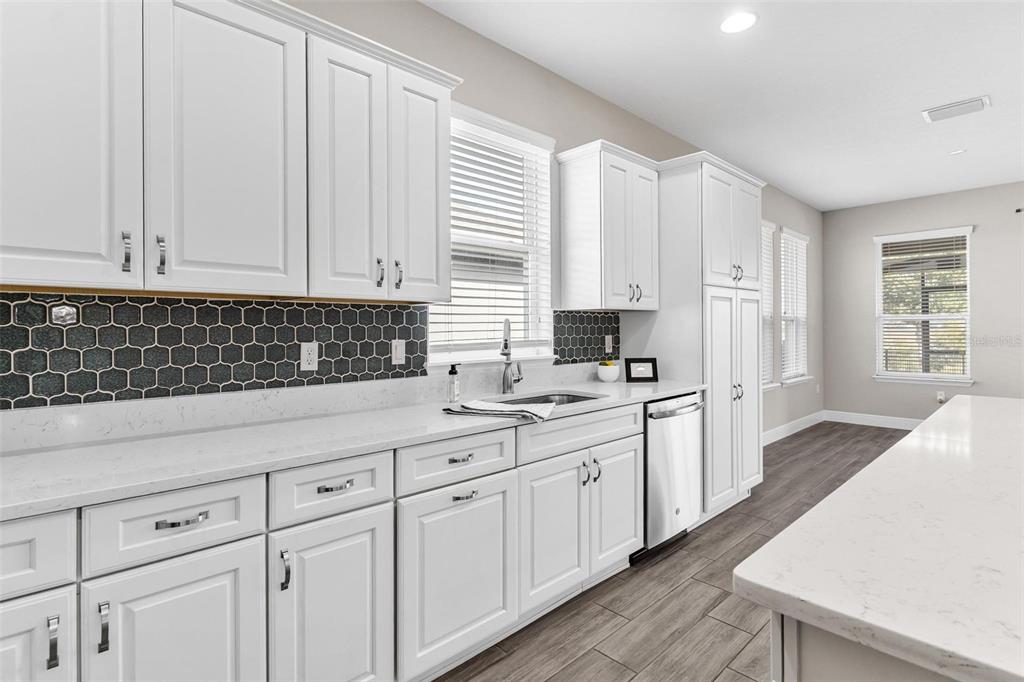 224 Silver Maple Road Groveland, FL 34736 - Photo 20 of 54 a kitchen with white cabinets and sink