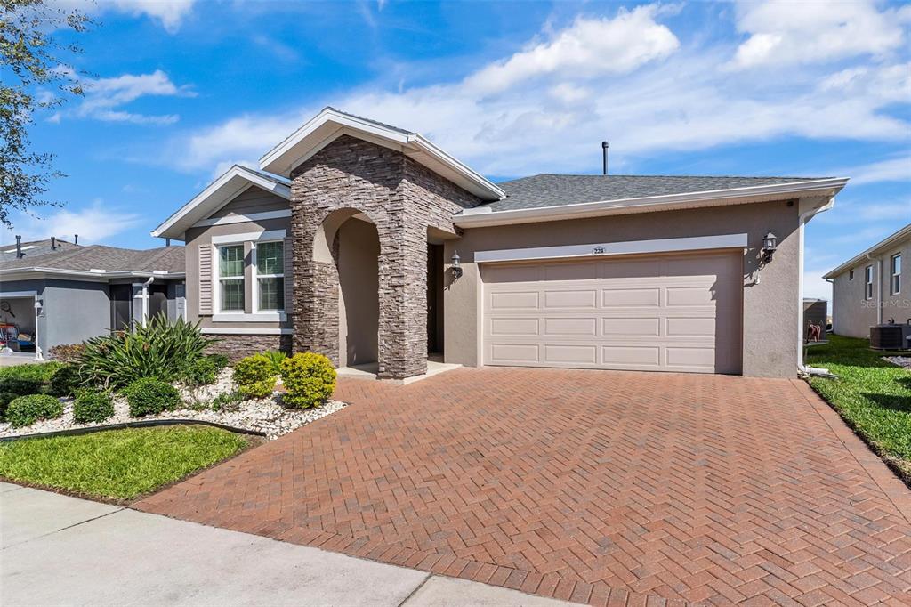 224 Silver Maple Road Groveland, FL 34736 - Photo 2 of 54 a front view of a house with a yard and garage