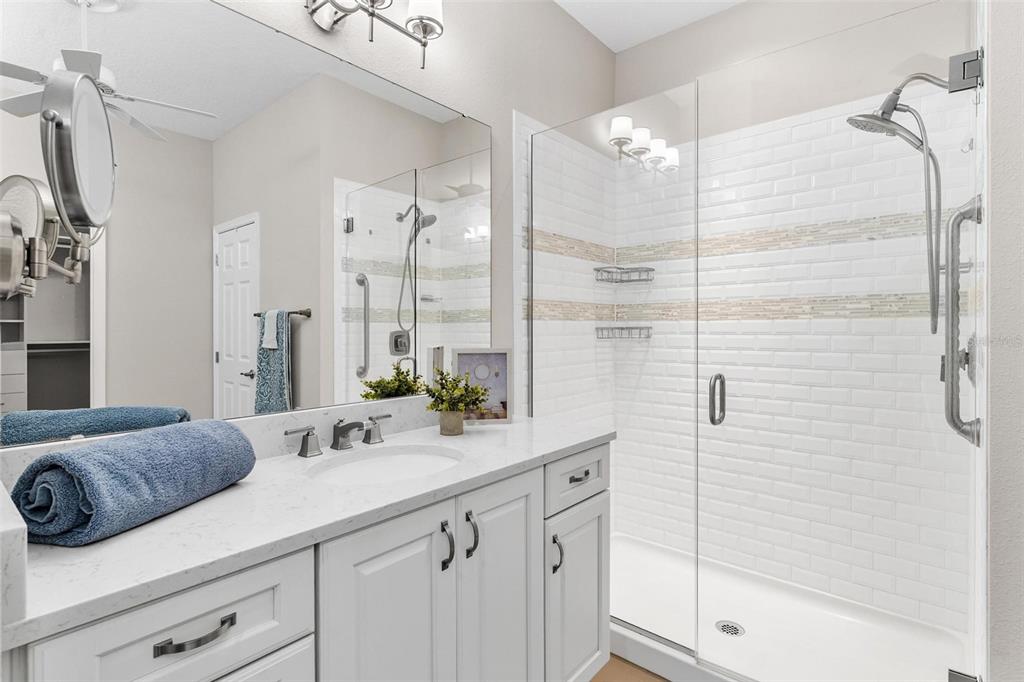224 Silver Maple Road Groveland, FL 34736 - Photo 30 of 54 a bathroom with a shower sink and mirror
