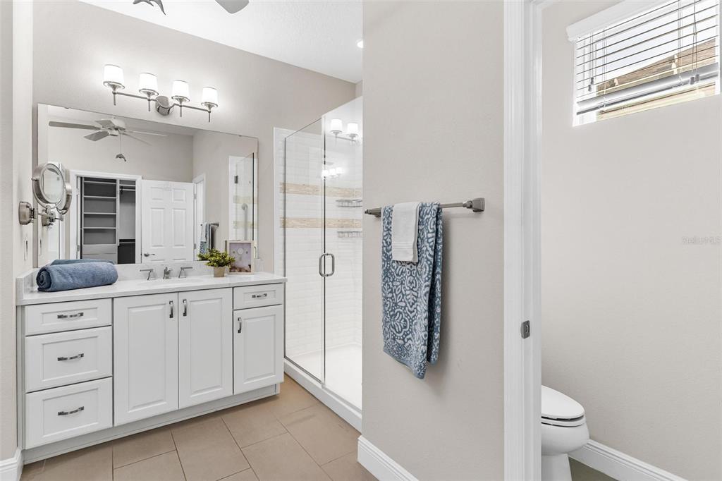224 Silver Maple Road Groveland, FL 34736 - Photo 31 of 54 a spacious bathroom with a granite countertop sink a toilet and a mirror