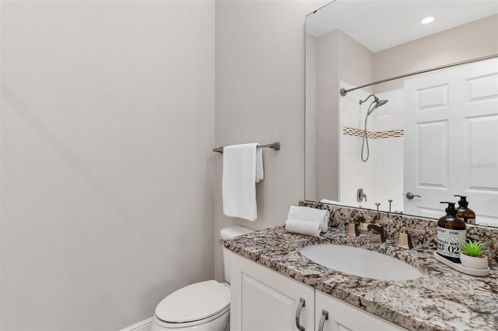 224 Silver Maple Road Groveland, FL 34736 - Photo 36 of 54 a bathroom with a granite countertop sink mirror vanity and toilet