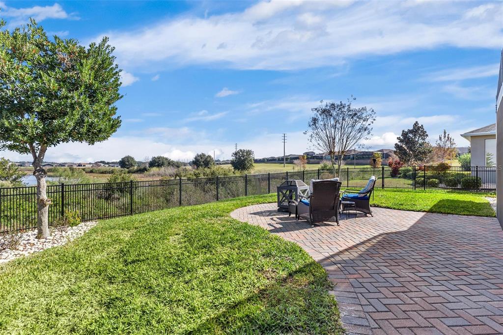 224 Silver Maple Road Groveland, FL 34736 - Photo 42 of 54 a view of a lake with a table and chairs under an umbrella