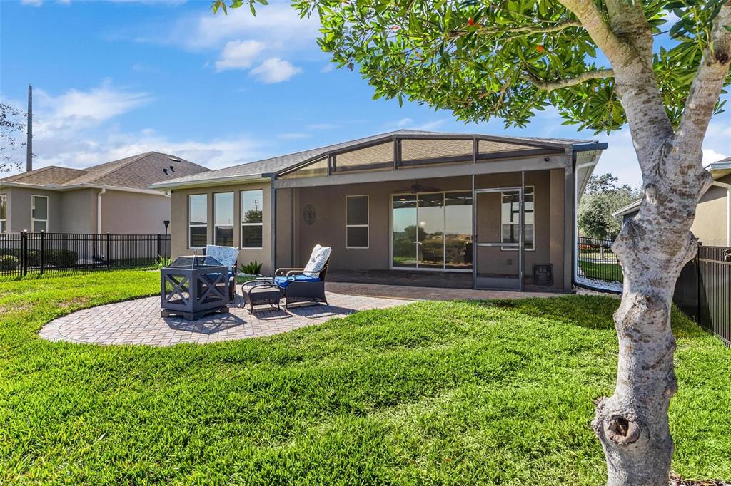 224 Silver Maple Road Groveland, FL 34736 - Photo 45 of 54 a front view of a house with a garden and patio