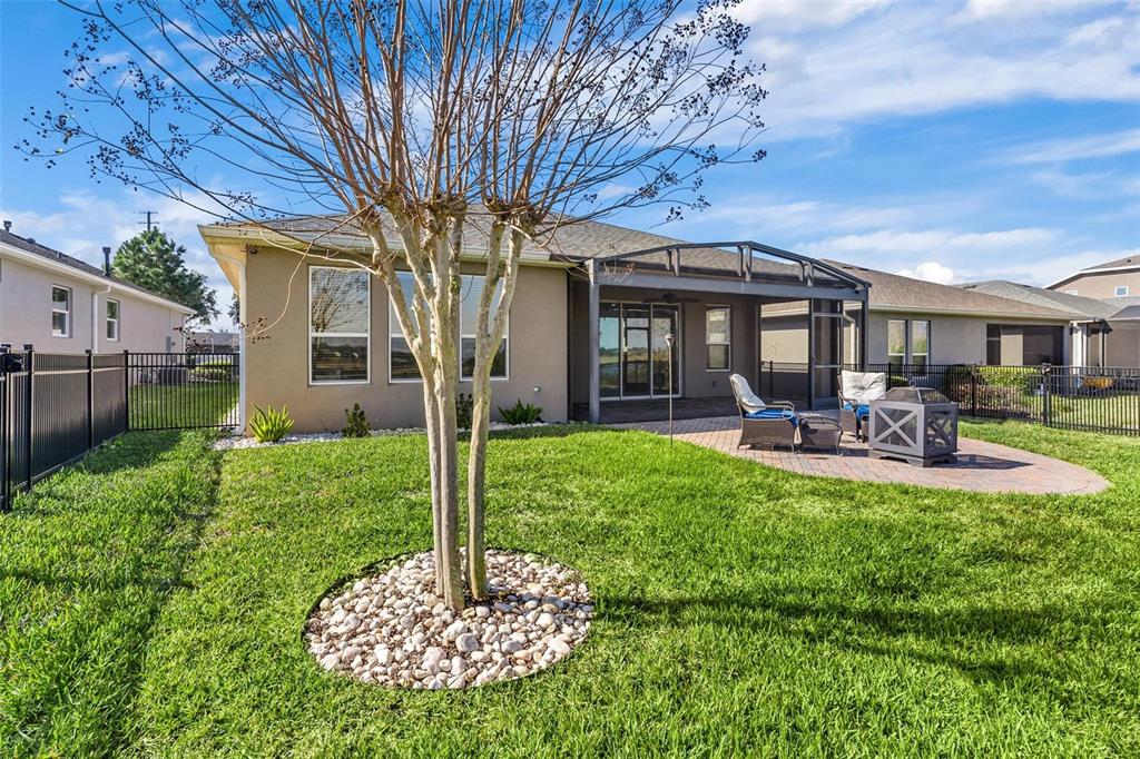 224 Silver Maple Road Groveland, FL 34736 - Photo 46 of 54 a front view of a house with garden and patio