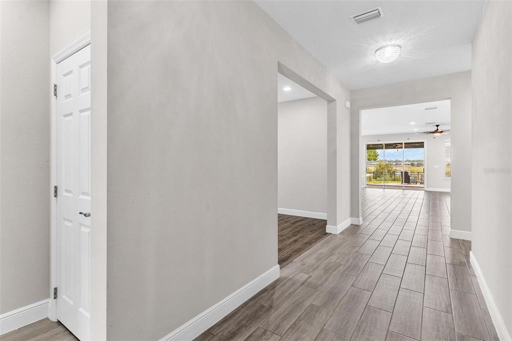 224 Silver Maple Road Groveland, FL 34736 - Photo 6 of 54 a view of a hallway with wooden floor