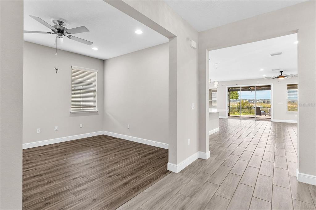 224 Silver Maple Road Groveland, FL 34736 - Photo 8 of 54 a view of an empty room with wooden floor and a window