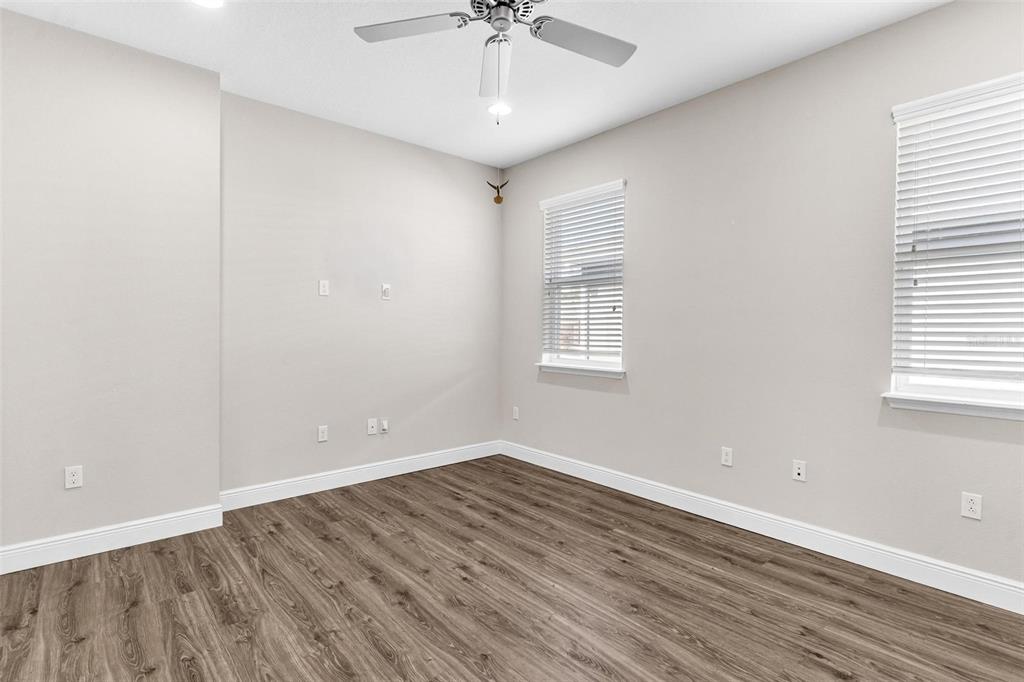 224 Silver Maple Road Groveland, FL 34736 - Photo 10 of 54 wooden floor in an empty room with a window