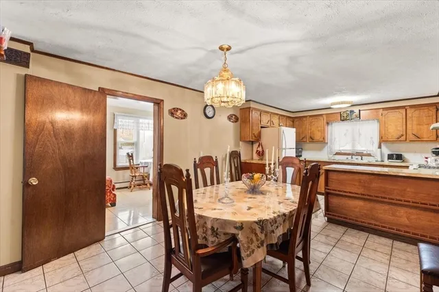 a view of a a dining room with furniture window and wooden floor