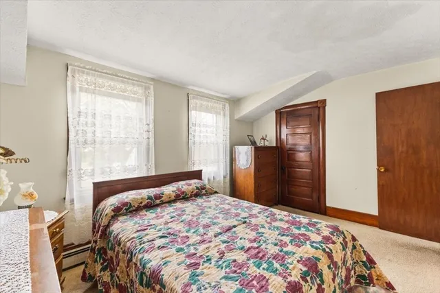 a bedroom with a bed and dresser