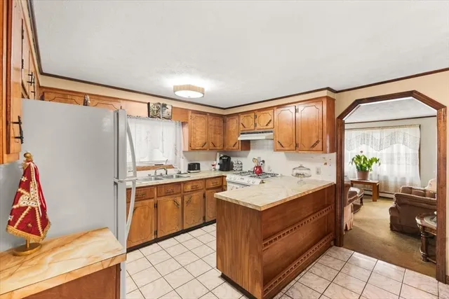 a kitchen with a sink stove and refrigerator