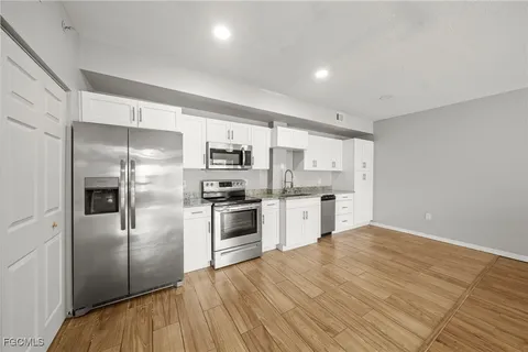 a kitchen with stainless steel appliances a refrigerator and a sink