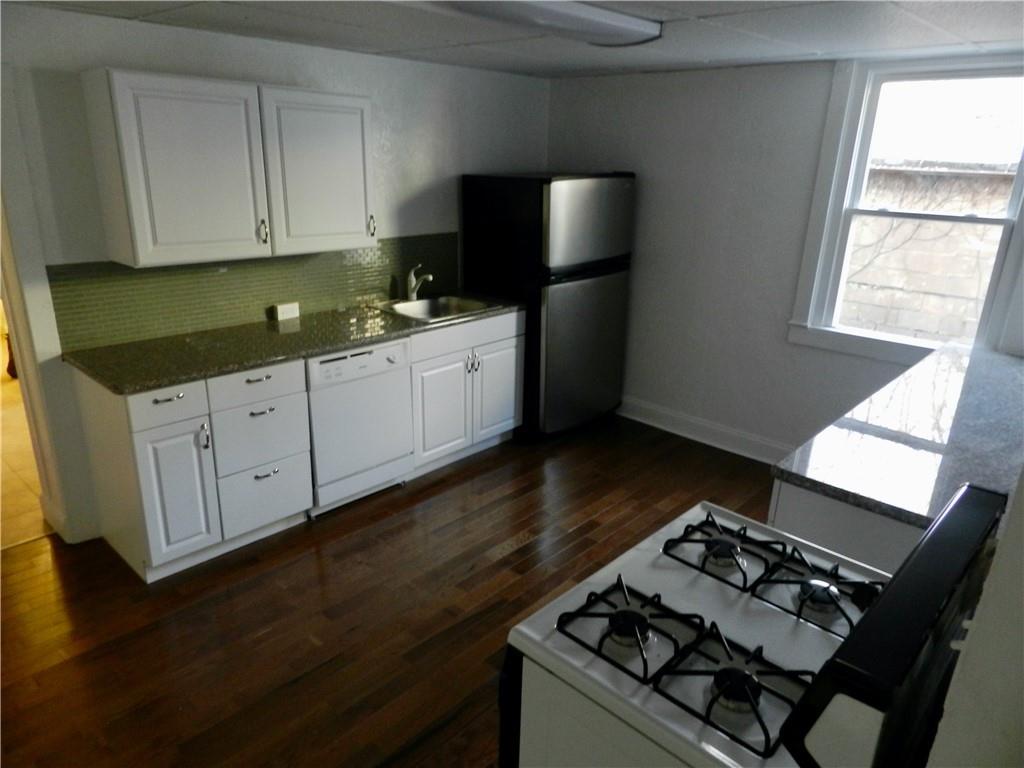 a kitchen with a stove a sink and a microwave