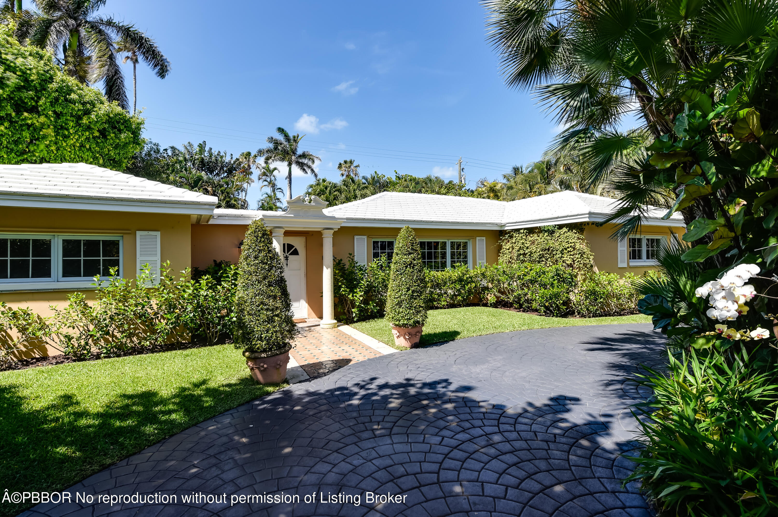 257 Fairview Road Palm Beach, FL 33480 - Photo 2 of 17 a front view of a house with a yard and fountain in middle