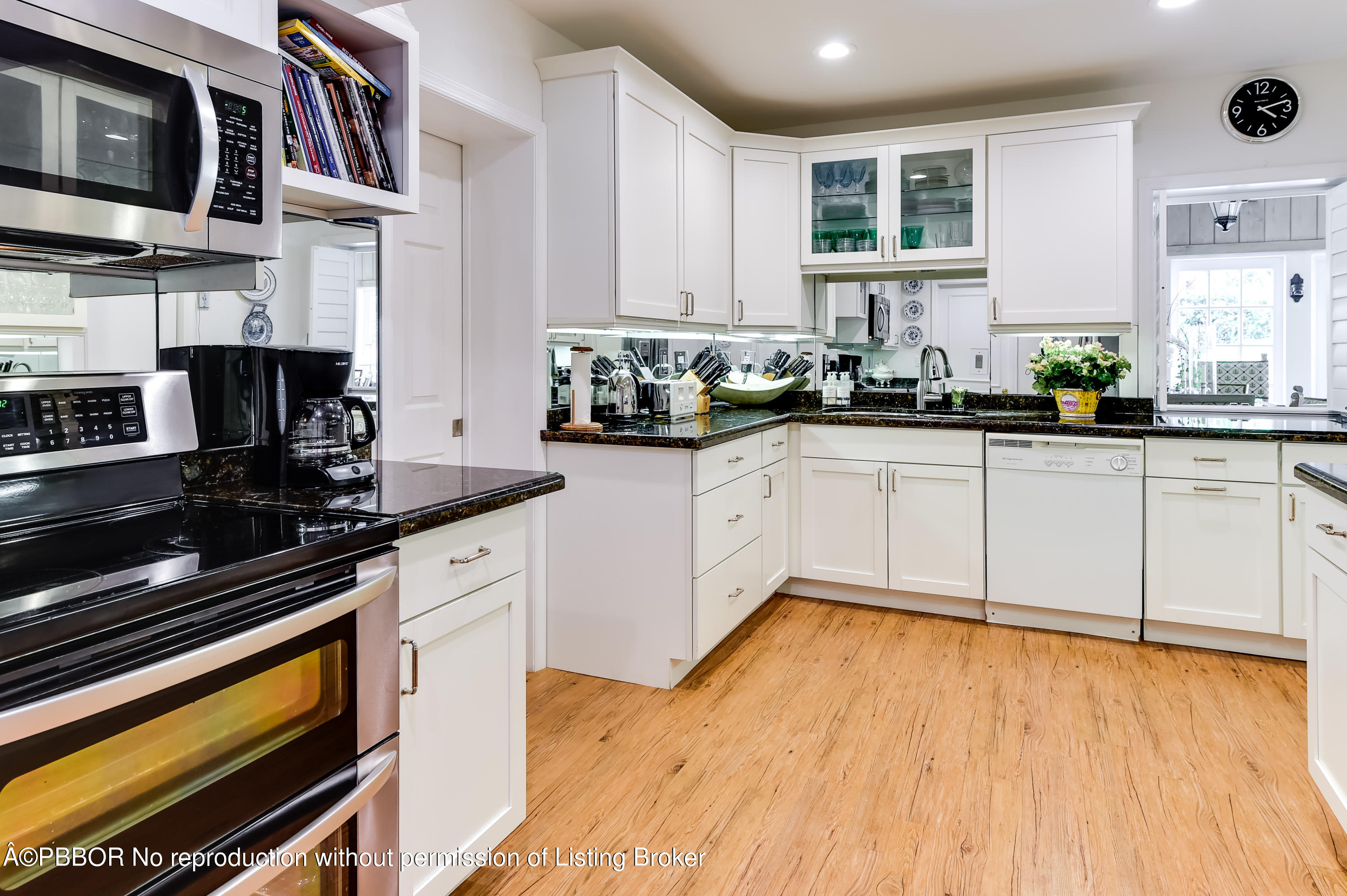 257 Fairview Road Palm Beach, FL 33480 - Photo 7 of 17 a kitchen with stainless steel appliances a sink dishwasher stove refrigerator and cabinets with wooden floor