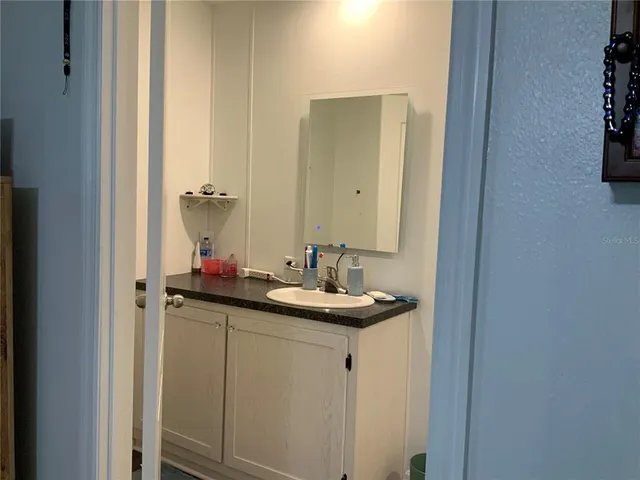 a bathroom with a sink and a mirror