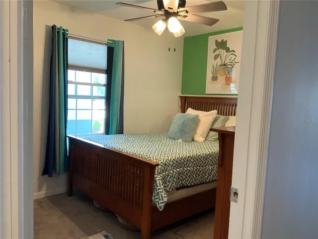 a bedroom with a bed and a window