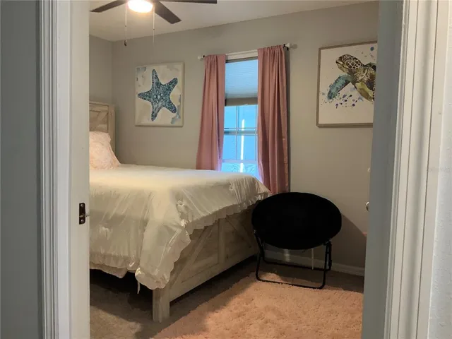 a bedroom with a bed and a painting on the wall