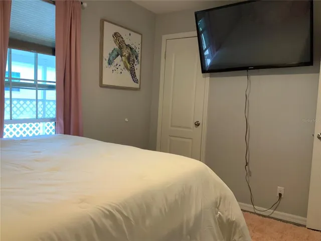 a bedroom with a bed and a flat screen tv
